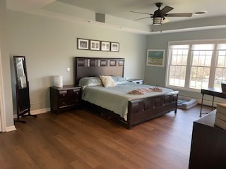 Before: bedroom with a dark bed and pale walls